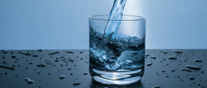 water being poured into a small glass