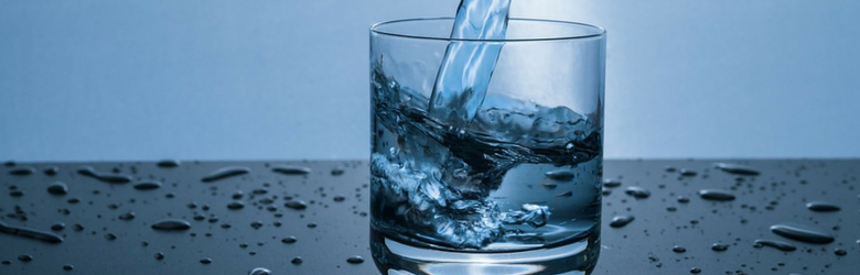 water being poured into a small glass