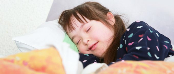 young down syndrome girl in bed