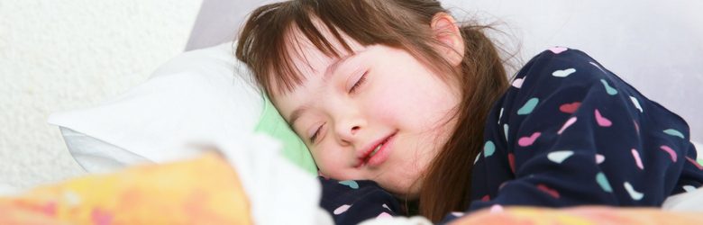 young down syndrome girl in bed
