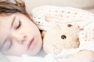 little girl sleeping with teddy bear