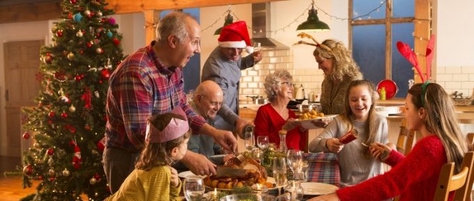 family helping to serve Christmas dinner at the table