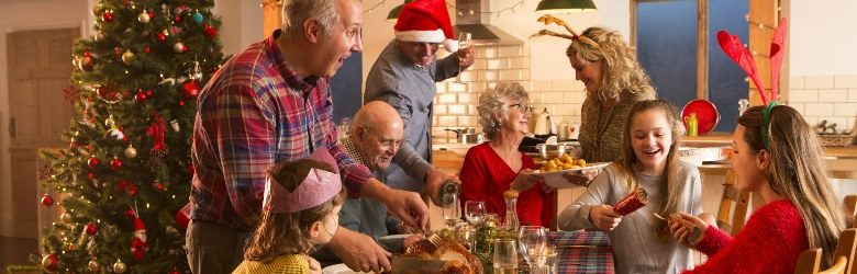 family helping to serve Christmas dinner at the table