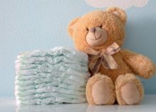 teddy bear beside pile of disposable nappies