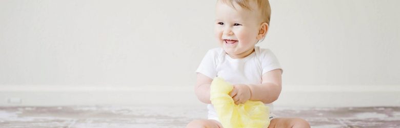 toddler sitting on the floor learning about toilet training