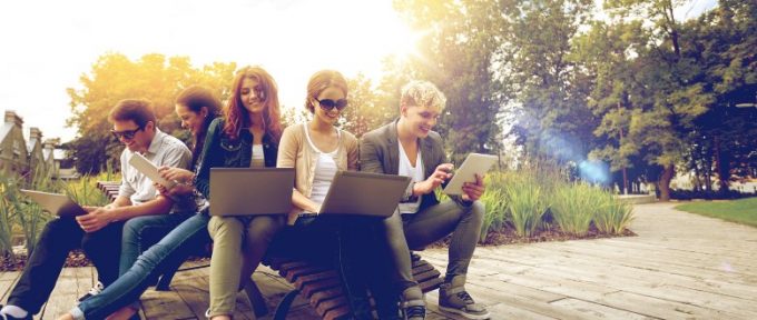 group of youths sat with their tablets and laptops