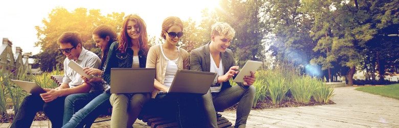 group of youths sat with their tablets and laptops