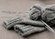 grey knitted gloves and wool material