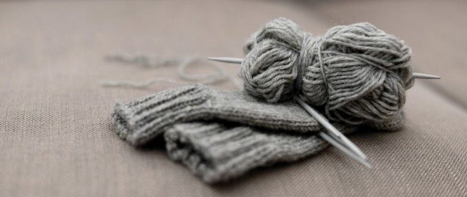 grey knitted gloves and wool material