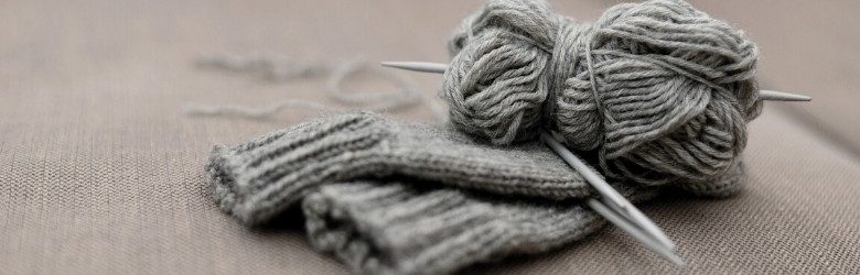 grey knitted gloves and wool material