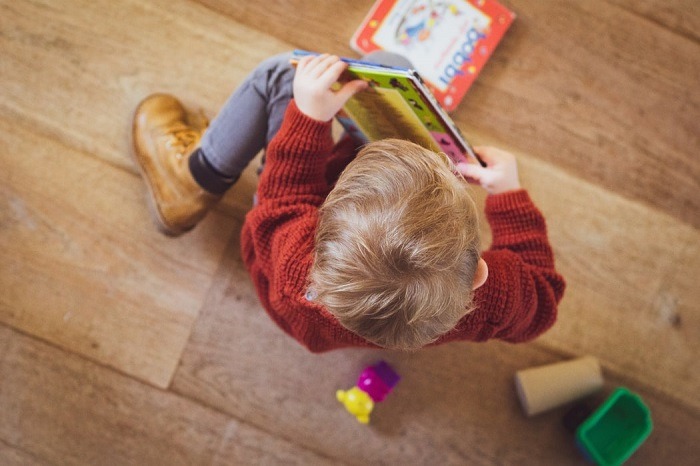 little boy looking at a book