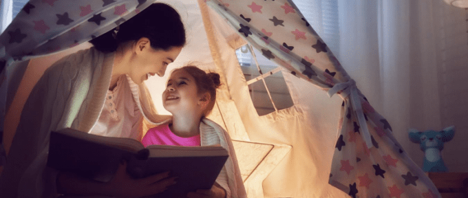 mum reading book to daughter for national read a book day