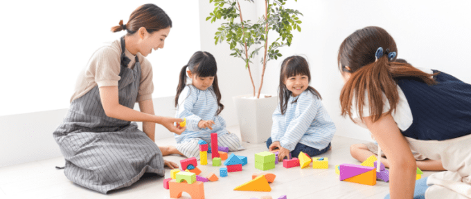 Children receiving an assessment or playing with adults