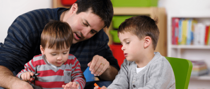 Two children playing with father