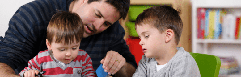 Two children playing with father