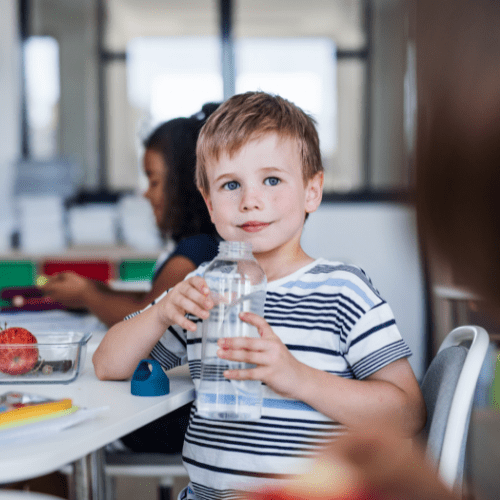 boy holding bottle of water