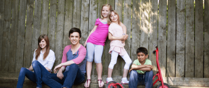 group of children and young people against wall