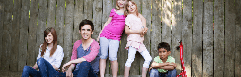 group of children and young people against wall