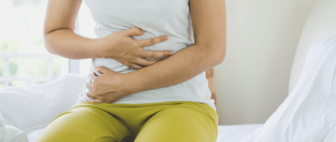 Woman holding her stomach in pain