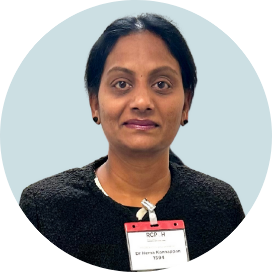 Professional portrait of a woman with dark hair, wearing a black outfit and a visible conference name badge.